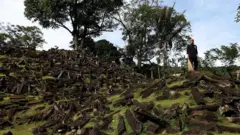 A man sweeps the Gunung Padang site in West Java, Indonesia