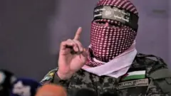 Abu Cubeyda,” afhayeenka milatariga ee guutada Al-Qassam.