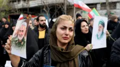 ईरान के प्रदर्शन के दौरान मारे गए सुरक्षाकर्मियों के जनाज़े में पहुंची एक महिला