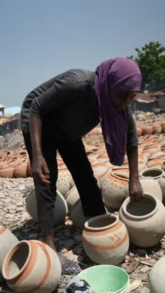 A woman with local pots