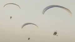 Hamas's Al-Qassam Brigades released this image of its fighters parachuting into Israel