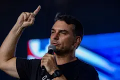 Flávio Bolsonaro falando ao microfone com o dedo levantado