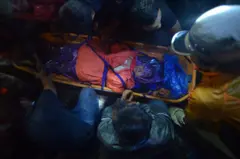 An Indonesian rescue team evacuates a survivor of the Mount Marapi eruption in Agam, West Sumatra province, Indonesia