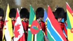 Sojas of di Coldstream Guards carry flags of di 53 Commonwealth kontris