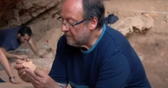 Valentín Villaverde looks at a fossil