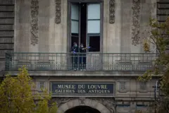 French Crime Scene Officers gesture as they examine the cut window and balcony of a gallery at the Louvre Museum the scene of a robbery at the world famous museum on October 19, 2025 in Paris, France. France's Culture Minister, Rachida Dati, announced the closure of the world-famous art museum on X due to the robbery taking place just after the Louvre opened to the public. It is being reported that millions of pound with of historic jewellery belonging to Napoleon and Empress Josephine has been stolen