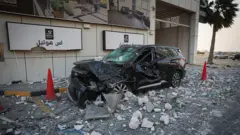 Four people had been wounded by Iranian attacks in Bahrain, one official told the BBC