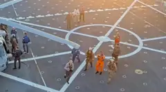 宇宙船オリオンを離れ輸送艦に運ばれた、オレンジ色の宇宙服のグローヴァー宇宙飛行士が任務完了を拍手している