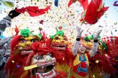 Chinese folk artists perform the lion dance at a temple fair to celebrate the Lunar New Year 