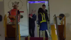 The moment the first lady appears to shove the French President