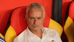Jose Mourinho in a white T-shirt sitting in the dock