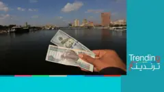 صورة لدولار ومائة جنيه والنيل في الخلفية