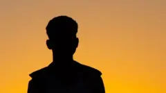 A silhouette of an anonymous African man.