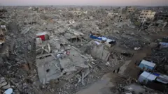 Long shot of Gaza rubble and demolished homes, bricks and concrete burying roads