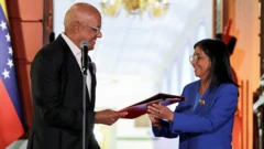 La presidenta interina de Venezuela, Delcy Rodríguez, recibe el texto de la ley de amnistía.