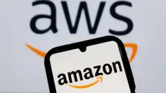 Big screen wey dem write AWS put wit phone for front of am wia em write Amazon