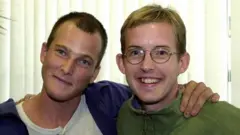 Tom Dyke e Paul Winder, abraçados e sorrindo