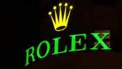 Logo de Rolex con su corona, en verde y amarillo