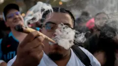 Мушкарац пуши велики џоинт