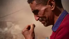 Man dey cry in front of di rubble of im home