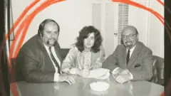 Jimmy Page assina o primeiro contrato da Led Zeppelin em 1968, ao lado do empresário da banda, Peter Grant, e do presidente da Atlantic Records, Ahmed Ertegun