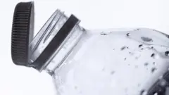 የምትጠጣበትን ኮዳ የምታጥብ ሴት