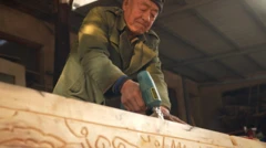 Coffin maker drilling into an empty coffin