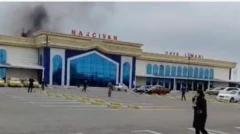 Nahçıvan havalimanının giriş kapısı görünüyor. Arkadan dumanlar yükseliyor.