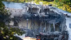 The view of the side of a building half demolished