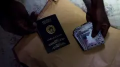 Pesin hold Ghana passport for hand