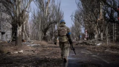 Un soldat qui marche, arme à la main