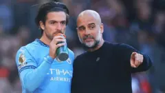 Mchezaji wa Man City Jack Grealish akiwa na Kocha Pep Guardiola
