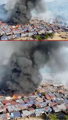 ගෙවල් පෙළකට ඉහලින් කළු දුම් වලාවක් ඇතිවී තිබෙන අයුරු පෙනේ.