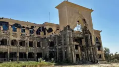 The blackened shell of the presidential palace in Khartoum, Sudan March 2025