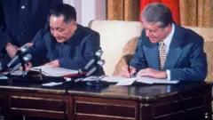 O líder chinês Deng Xiaoping e o então presidente americano, Jimmy Carter, assinam em Washington, em janeiro de 1979, um acordo de cooperação entre China e EUA nas áreas de ciência e tecnologia.