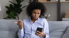 Woman dey wonder as she dey check her phone