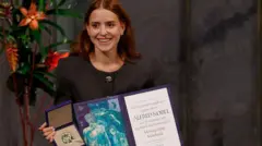 Ana Corina Sosa exhibe el diploma y la medilla del premio Nobel.