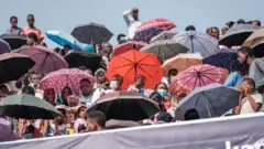 A crowd wait in a stadium in Jimma on June 16, 2021 for an electoral campaign rally of Ethiopian Prime Minister Abiy Ahmed ahead of the June 21, 2021 vote.