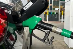 A gas pump is seen connected to a car at a refuelling station near Kraków, Poland
