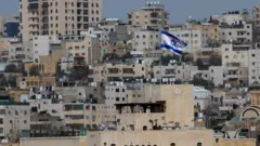 An Israeli flag flies from an Israeli settlement in Hebron, in the occupied West Bank (9 February 2026)