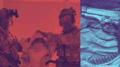 Двоє співробітників СБУ тримають арештованого злочинця