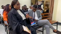 Ishimwe Dieudonne uzwi nka Prince Kid (iburyo) hamwe n'umwunganizi we Emeline Nyembo mu rukiko i Kigali mu kwezi kwa kane 2023