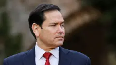 Headshot of Rubio who looks off to the side. There's a blurred background