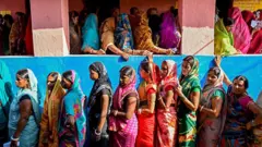 Mulheres eleitoras em fila para depositar seu voto em uma seção eleitoral durante a primeira fase das eleições legislativas em 6 de novembro de 2025, na circunscrição de Raghopur, distrito de Vaishali, no Estado indiano de Bihar