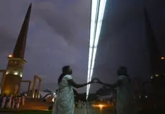 A Sri Lankan woman reads names on a memorial for fallen soldiers during the National War Heroes Day in Colombo on May 19, 2019. - Sri Lanka's president marked the 10th anniversary of the end of a protracted war with Tamil rebels on May 19 by vowing to crush Islamist militants responsible for Easter bombings that killed 258 people. (Photo by LAKRUWAN WANNIARACHCHI / AFP) (Photo by LAKRUWAN WANNIARACHCHI/AFP via Getty Images)