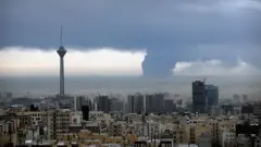 Coluna de fumaça sobe do depósito de petróleo de Shahran após ataques americanos e israelenses em 8 de março de 2026 ao Irã