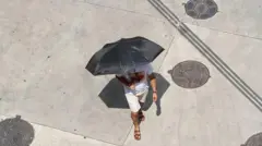 Homem andando com guarda-chuvas