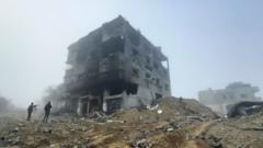 Two figures by a bombed-out building in Khan Younis