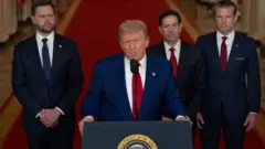Trump addresses the nation on Saturday night to inform them of the US air strikes on Iranian nuclear facilities, dressed in a blue suit and red tie and flanked by JD Vance, Marco Rubio and Pete Hegseth
