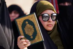 Supporter of Iraqi Shi'ite cleric Moqtada al-Sadr, holds a Koran during the demonstration in the city of Mosul, to condemn the burning of the Koran in Sweden. An Iraqi citizen living in Sweden, stomped on the Koran and set several pages alight in front of Stockholm's largest mosque in Sweden on the first day of Eid al-Adha. (